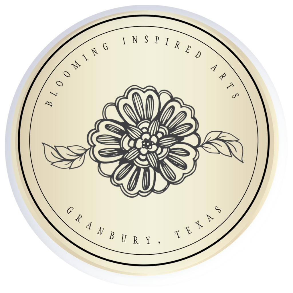 gold button with floral elements identifying the Blooming Inspired Arts Logo